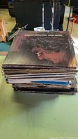 Stack of vinyl LPs on table with Randy Newman Sail Away top cover