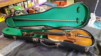Open violin case showing violin and bow inside