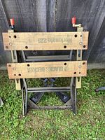 Folded view of Black & Decker Workmate 225 showing wooden top panels with branding and metal frame.