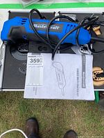 Full view of the Mastercraft multi-crafter tool in a case with various blade attachments and user manual.