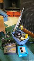 Overview of lot contents including Mouth Tube amplifier, cables in blue tote and cymbal stand parts