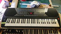 Full keyboard including keys, speakers, control panel with buttons and display.