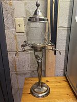 Full front view showing entire dispenser including lid and spigots