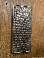 Top view of the rectangular metal box showing detailed woven basket pattern.