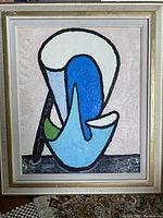 Framed mixed media abstract painting with whimsical shapes and artist signature visible.