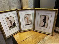 Group photo of the three framed Art Nouveau prints displayed side by side, showing overall condition and frame style