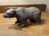 Side view of cast iron polar bear figurine showing textured fur and shape