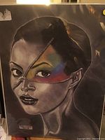 Full image of the signed artwork showing the woman with zipper motif across the face and colored details.
