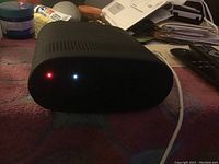 Back or bottom view of the black Bose speaker with LED lights turned on.