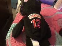 Black Chandler Beanie Baby with embroidered 'Chandler 12' on back and attached tag