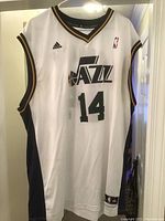 Front view of the white Utah Jazz basketball jersey featuring #14 Hornacek, Adidas branded, NBA logo patch, size XXL tag visible. The jersey shows signs of wear and requires cleaning.