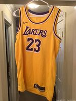 Front view of yellow Lakers basketball jersey with number 23 and LeBron James association.