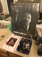 Photo showing a large black-and-white image of Martin Luther King Jr. with raised hand and the text "I HAVE A DREAM". Also shows two smaller photos, one of Coretta Scott King and one family photo of the King family.