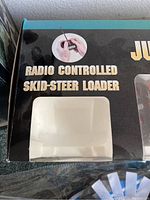 Radio controlled skid-steer loader packaging with text "Radio Controlled Skid-Steer Loader"