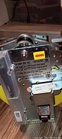 Close-up photo of the machinery unit with a label showing model number SA GBP 702.02 and serial 59314701, other technical details including voltage and rpm speeds.