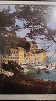 Full front view of the photographic art print showing the Italian harbor scene with colorful buildings and boats, framed by trees.