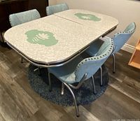 Full set from angled view showing table and four chairs