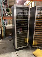 Front view of wine cooler with closed glass door and stainless steel frame
