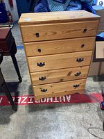 Front view of the pine dresser showing five drawers with metal handles, one handle loose.