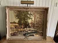 Full view of the framed landscape print with attached picture lamp