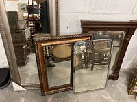 Overview of four mirrors, showing varying frame styles and sizes, largest mirror is silver framed and measures approximately 20" x 42".