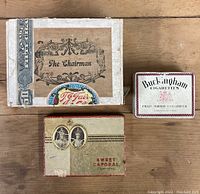 Overview photo showing three vintage boxes: The Chairman paper cigar box, Buckingham Cigarettes tin box, Sweet Caporal Cigarettes paper box.