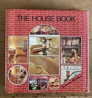 Front cover of the book showing the title and author with a red brick pattern and interior design photos.