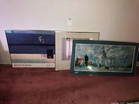 Two gallery posters side-by-side, titles visible: Wolf Kahn and Carl Locher, leaning against wall