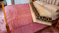 Queen reversible comforter on bed, showing dusty rose side