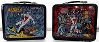 Two tin lunchboxes with Madman and The Atomics artwork by Mike Allred, showing front sides with colorful comic illustrations.