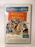 Artists and Models US one-sheet movie poster, shrinkwrapped on board, featuring Dean Martin and Jerry Lewis with colorful illustration, 27x41 inches.