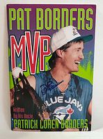 Image of 'Pat Borders MVP' booklet cover featuring Pat Borders in Blue Jays uniform holding a trophy, signed by Pat Borders in blue ink.