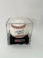 Baseball in acrylic display case showing signature on sweet spot