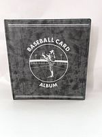 Front view of the black baseball card binder album with a white illustration of a pitcher and the text 'BASEBALL CARD ALBUM'