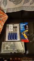 Full lot showing unopened 4-piece blue-handled wood chisel set, Ultra 37-piece socket set in plastic case, and Mastercraft Grip Driver with bits in original packaging.
