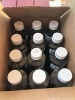 Top view inside box showing 12 bottles with white caps.
