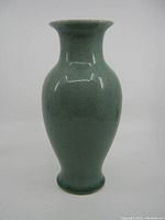 Front view of green crackle glaze Chinese vase on white background.