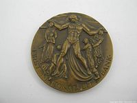 Obverse side of bronze medallion showing human figures and "FIRST NATIONAL CITY BANK" text