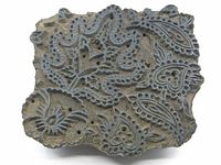 Top view showing detailed carved paisley and floral design of the wooden textile printing block.