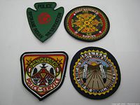 Four Native American tribal police patches grouped together showing varied shapes and designs highlighting specific tribal police and fire services.