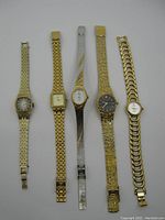 Top view of five vintage ladies watches in a row showing different styles and bands
