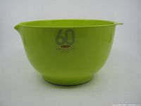 Side view photo of the lime green 3-liter Margrethe bowl showing the full shape, handle, and pouring spout.