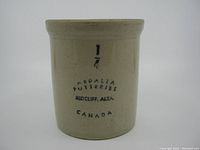 Front view showing black stamp markings '1/4 Medalta Potteries Redcliff, Alta. Canada' on the pot