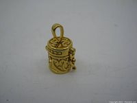 Front angled view of the cylindrical sterling silver box pendant showing detailed scroll patterns and loop.