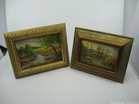 Both original oil paintings with frames showing vintage condition and color.