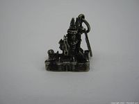 Front view of the antique sterling silver Disney castle charm, showing detailed castle design and patina from age.