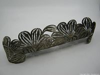 Front angled view of the handmade wire filigree metal basket showing detailed petal-shaped filigree design and overall shape.