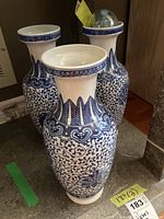Three blue and white ceramic vases featuring intricate floral and geometric designs, approximately 13 inches tall.