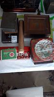 Overview of lot showing bamboo cylinder, wooden and metal boxes, tins, hat and glass dish
