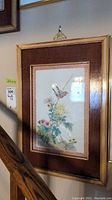 Framed Asian-style bird print showing a bird on a floral branch, wood frame, measurement sticker 22x15 inches visible.
